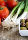 Bowl with olives, tomatoes and green onion