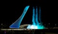 Bowl of the Olympic flame Firebird and singing Fountain in the Olympic park in the evening