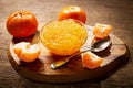 Bowl of orange tangerine or mandarin jam with fresh fruits Royalty Free Stock Photo