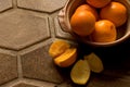 Bowl of oranges on Spanish tile floor Royalty Free Stock Photo