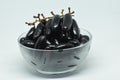 Bowl of organic black grapes on a white background Royalty Free Stock Photo