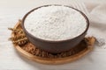 Bowl with organic flour, grains of wheat and spikelets on white wooden table, closeup Royalty Free Stock Photo