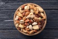 Bowl with organic mixed nuts on wooden background Royalty Free Stock Photo