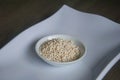 Organic Pearl barley in white ceramic bowl on wooden background Royalty Free Stock Photo