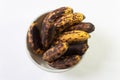 Bowl of overripe bananas viewed from overhead, isolated on white