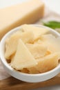 Bowl with parmesan cheese pieces on table, closeup Royalty Free Stock Photo