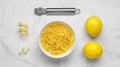 Bowl with peel pieces, fresh lemons and zester on white marble table, flat lay