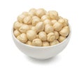 Bowl of peeled hazelnuts isolated on white background. Top view Royalty Free Stock Photo