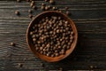 Bowl with peppercorns on wooden table, top view Royalty Free Stock Photo