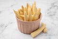 Bowl and pickled baby corn on white marble table