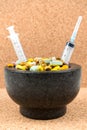 Bowl of pills and syringes addiction concept Royalty Free Stock Photo