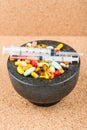 Bowl of pills and syringes addiction concept Royalty Free Stock Photo