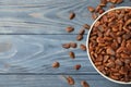 Bowl with pine nuts and space for text on wooden background Royalty Free Stock Photo