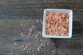 Bowl of Pink Himalayan Salt on a rustic wood plank board with room for copy space Royalty Free Stock Photo