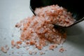 Bowl of pink himalayan salt on white table Royalty Free Stock Photo