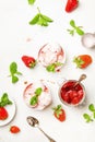 Bowl of pink strawberry ice cream and fresh berries on white background. Top view Royalty Free Stock Photo