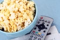 Bowl of popcorn and remote control Royalty Free Stock Photo
