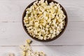 Bowl with popcorn on wooden table Royalty Free Stock Photo