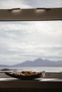 Bowl of pot pourri with landscape in the background lit by the s