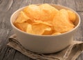 Bowl of potato chips in a black wooden background. Royalty Free Stock Photo