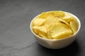 Bowl of potato chips on grey table Royalty Free Stock Photo