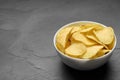 Bowl of potato chips on grey table Royalty Free Stock Photo