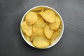 Bowl of potato chips on grey table Royalty Free Stock Photo