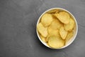 Bowl of potato chips on grey table, top view Royalty Free Stock Photo