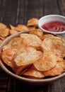 Bowl with potato crisps chips and ketchup on wooden board Royalty Free Stock Photo