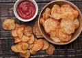 Bowl with potato crisps chips and ketchup on wooden board Royalty Free Stock Photo