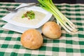 Bowl of potato leek soup with rolls Royalty Free Stock Photo