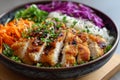 Bowl of prepared salad with rice, chicken, white and red cabbage