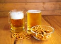 Bowl of pretzels and two mugs of beer Royalty Free Stock Photo