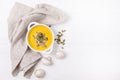 Bowl of Pumpkin and Mushrooms Soup with Cream and Pumpkin Seeds on Linen Napkin White Wooden Background Top View Copy Space Royalty Free Stock Photo