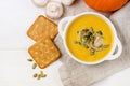 Bowl of Pumpkin and Mushrooms Soup with Cream and Pumpkin Seeds on Linen Napkin White Wooden Background Raw Mushrooms Pumpkin Royalty Free Stock Photo