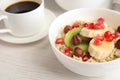 Bowl of quinoa porridge with hazelnuts, kiwi, banana and pomegranate seeds served for breakfast Royalty Free Stock Photo