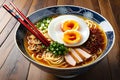 Bowl of ramen, top view, rich golden broth with spiraling noodles at the center, half-soft-boiled egg glistening