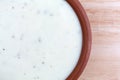 Bowl of ranch dressing on a wood table top Royalty Free Stock Photo