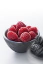 Bowl of raspberries against white background
