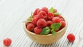 Bowl with raspberries and leaves Royalty Free Stock Photo