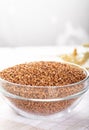 Bowl of raw buckwheat on wooden background. Buckwheat groats hulled seeds in bowl