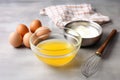 bowl of raw eggs next to a whisk on a kitchen counter Royalty Free Stock Photo