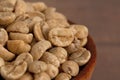 Bowl of Raw Green Coffee Beans on a Wooden Table Royalty Free Stock Photo