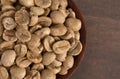 Bowl of Raw Green Coffee Beans on a Wooden Table Royalty Free Stock Photo