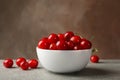 Bowl with red cherry on gray table Royalty Free Stock Photo
