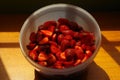 Bowl of red strawberries on a woodden table Royalty Free Stock Photo