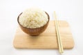 Bowl of rice and chopsticks on wooden Royalty Free Stock Photo