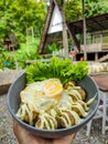 A bowl of rice with deep fried meat ball mayo sauce and egg on top Royalty Free Stock Photo