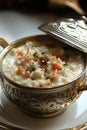 A bowl of rice pudding on a white plate with a silver lid Royalty Free Stock Photo