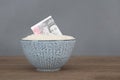 A bowl of rice rations and pound notes Royalty Free Stock Photo